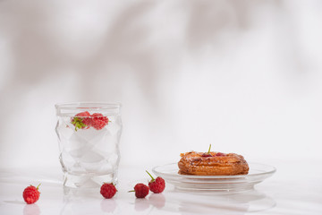 Sweet summer dessert, homemade puff pastry with berries , served with cold raspberry cider, fresh raspberries. On a white marble table, copy space top view