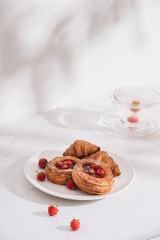 Raspberry filled pastries with sugar sprinkles. Selective focus.