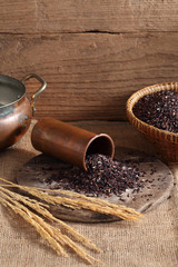 riceberry rice in measuring cup on table with a blank space for a text, riceberry rice in kitchen background