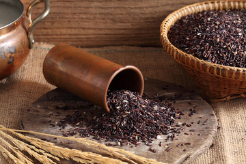 close up riceberry rice in measuring cup on table, riceberry rice in kitchen background