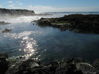 A hot spring lagoon on a sunny summer afternoon near the ocean in Reykjanes, Iceland