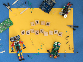 Back to school concept. A metal robot and an electronic board that can be programmed. Robotics and...