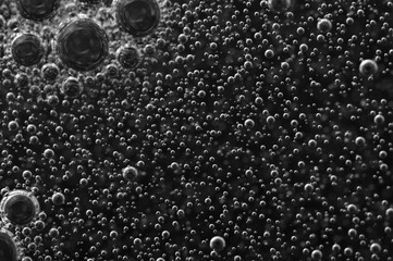 Bubbles of oxygen or air in a dark liquid. For projects with liquid or oil. Macro