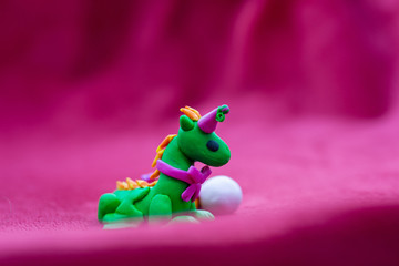 Cute party dragon with balloon and cake, polymer clay 3D object
