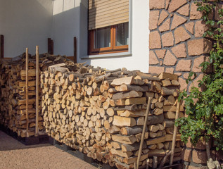 heaps of firewood well placed outside a country house. lombardy - Italy