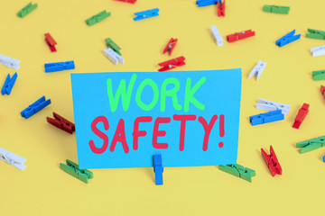 Writing note showing Work Safety. Business concept for policies and procedures in place to ensure health of employees Colored clothespin papers empty reminder yellow floor background office