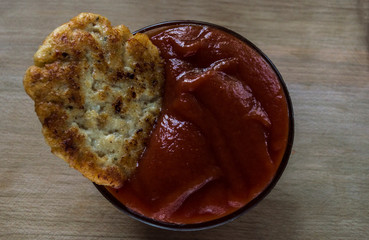 closeup of meat cutlet in red tomato sauce