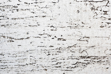 Old board covered with cracked white paint. Background with abstract texture.