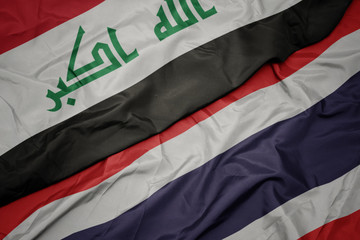 waving colorful flag of thailand and national flag of iraq.