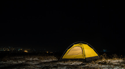 Camping for a starry night. The tent glows under a night sky full of stars. Milky way. leisure tourists. for friends. the first snow. the journey, autumn