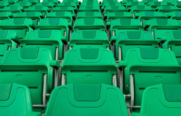  Front view row of green numbered folding seats or chair in sports complex outdoor stadium,.public sport arena athletics