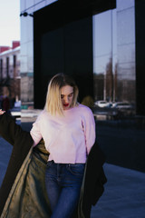 portrait of a blonde girl in a coat