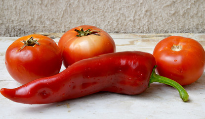 organic tomatoes and red peppers on wooden background