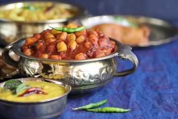 traditional Indian home-cooked dinner. dishes of national Indian cuisine on a dark blue background. rice, dal, sabji, pakora. top view, copy space