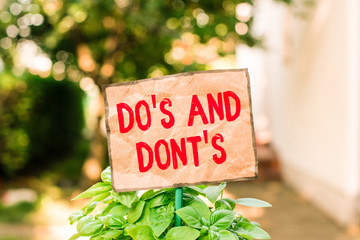 Writing note showing Do S And Dont S. Business concept for Rules or customs concerning some...
