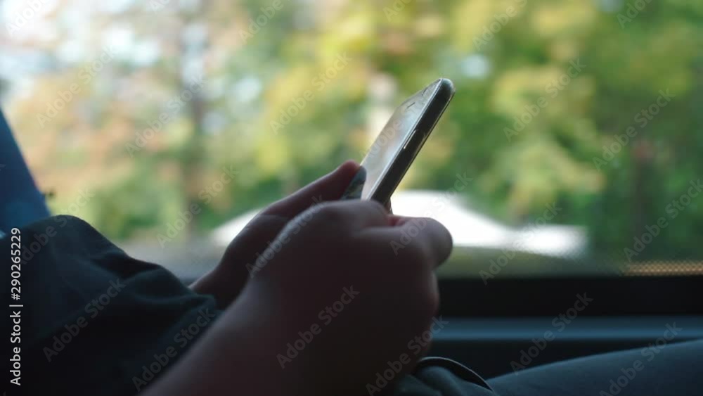 Poster child holds a smartphone in the bus