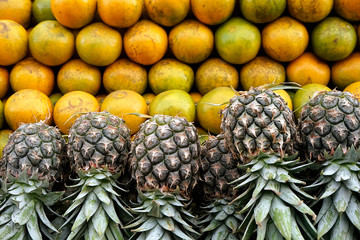 fresh fruit in maket, pineapple and  Tangerine oranges for healthy