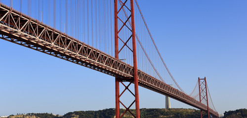 The April 25 Bridge links central Lisbon with the south bank of the Tagus River, the monument of Cristo Rei overlooks the river from a towering pedestal on the south bank, Portugal