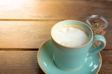 Hot coffee latte  and rock sugar brown on wood table.
