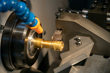 The multi-tasking CNC machine slot cutting at the brass shaft parts with the slot  tool. The hi precision  parts manufacturing process by CNC lathe machine with the cutting tools.