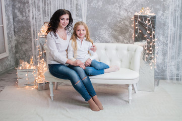 Two very pretty girls, sisters celebrates Christmas, new year. Girls in the New Year's interior of...