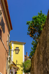 Picturesque Street Scene and architecture of Sintra, Portugal. Charming colourful houses against clear blue sky.