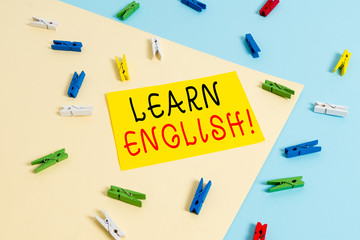 Text sign showing Learn English. Business photo text gain acquire knowledge in new language by study Colored clothespin paper empty reminder yellow blue floor background office