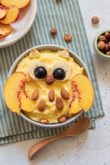 Kids breakfast polenta porridge with fruit look like a cute owl