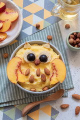 Kids breakfast polenta porridge with fruit look like a cute owl