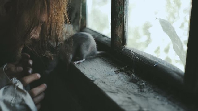 Crazy Terrible Maniac In Basement With Window Playing With Rat