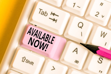 Conceptual hand writing showing Available Now. Concept meaning you can find it obtain or operable at this current moment White pc keyboard with note paper above the white background