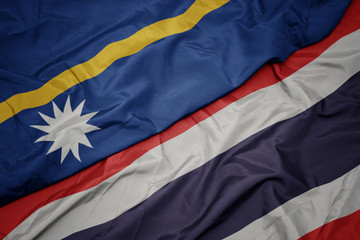 waving colorful flag of thailand and national flag of Nauru .