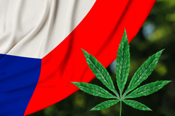 green leaf of hemp and the beautiful silk national flag of the czech republic, the concept of...