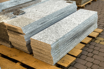 Piles of granite marble slabs.  Stone sheets for decorative construction.