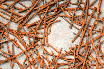 Fototapeta premium Rusty nails on a cement metal background