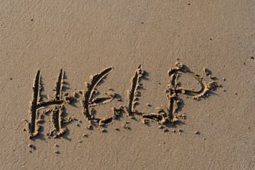 Fototapeta premium Help, written as a message on the sand