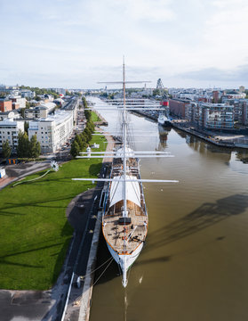 Aerial front view of Swan Of Finland on Aurajoki river at summer with city center in the background in Turku, Finland