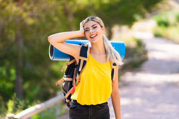 Teenager girl hiking at outdoors smiling