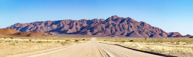 Gravel road leading into a mountainous landscape near Spreetshoogte Pass, Namibia
