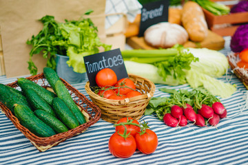 Close-up shot of autumn harvest sale on farm market fresh organic vegetables fruit and herbs on table. Health lifestyle, useful nutrition and shopping concept.