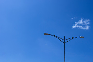 Electricity post stands alone (Street Lights) against the blue sky with clouds. copy space.