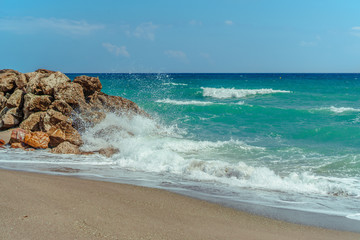wave hitting the stones on the shore