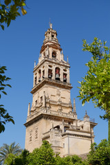 Fototapeta na wymiar Bell tower of Mezquita, Mosque-Cathedral against clear blue sky, Cordoba. Andalusia, Spain.