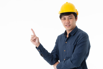 Asian young engineer with yellow helmet hat pointing finger up at blank screen, perfect for adding text, isolated on white background with copy space. Business construction and home design concept.