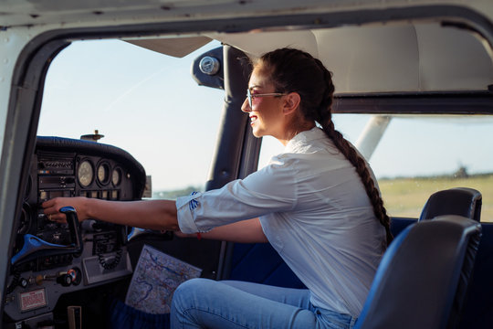 Female pilot preparing for a flight in a light aircraft