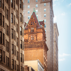 Old house in between skyscrapers