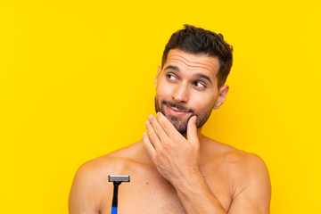 Man shaving his beard thinking an idea