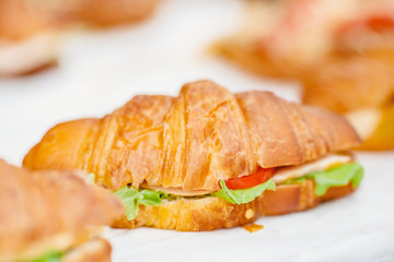 Sandwich croissants with green salad and jamon meat, european breakfast. Catering concept