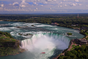 Horseshoe Falls including Hornblower Boat sailing on Niagara River, Canada and USA natural border