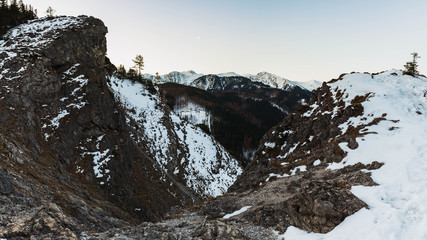 Rocky trail in winter condition to Nosal peak, view towards Kasprowy Wierch peak.